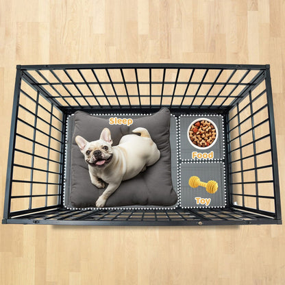 Pet crate with a dog lying on a pillow, food bowl, and toy on a wooden floor.