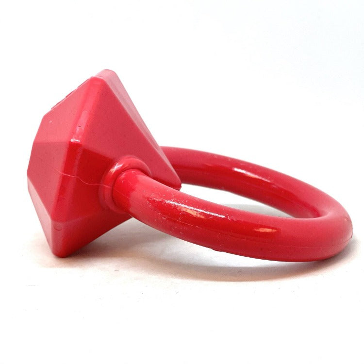 Red plastic dog toy with a ring on a white background