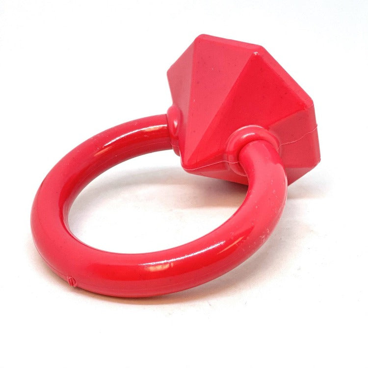 Red plastic ring with geometric design on a white background
