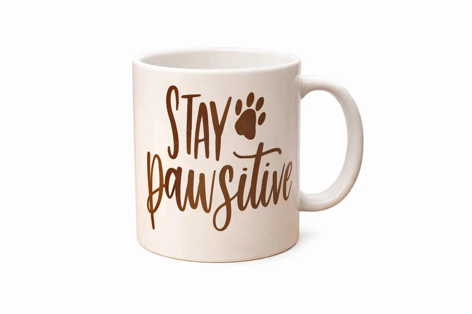 White mug with 'Stay Pawsitive' text and paw print design on a white background