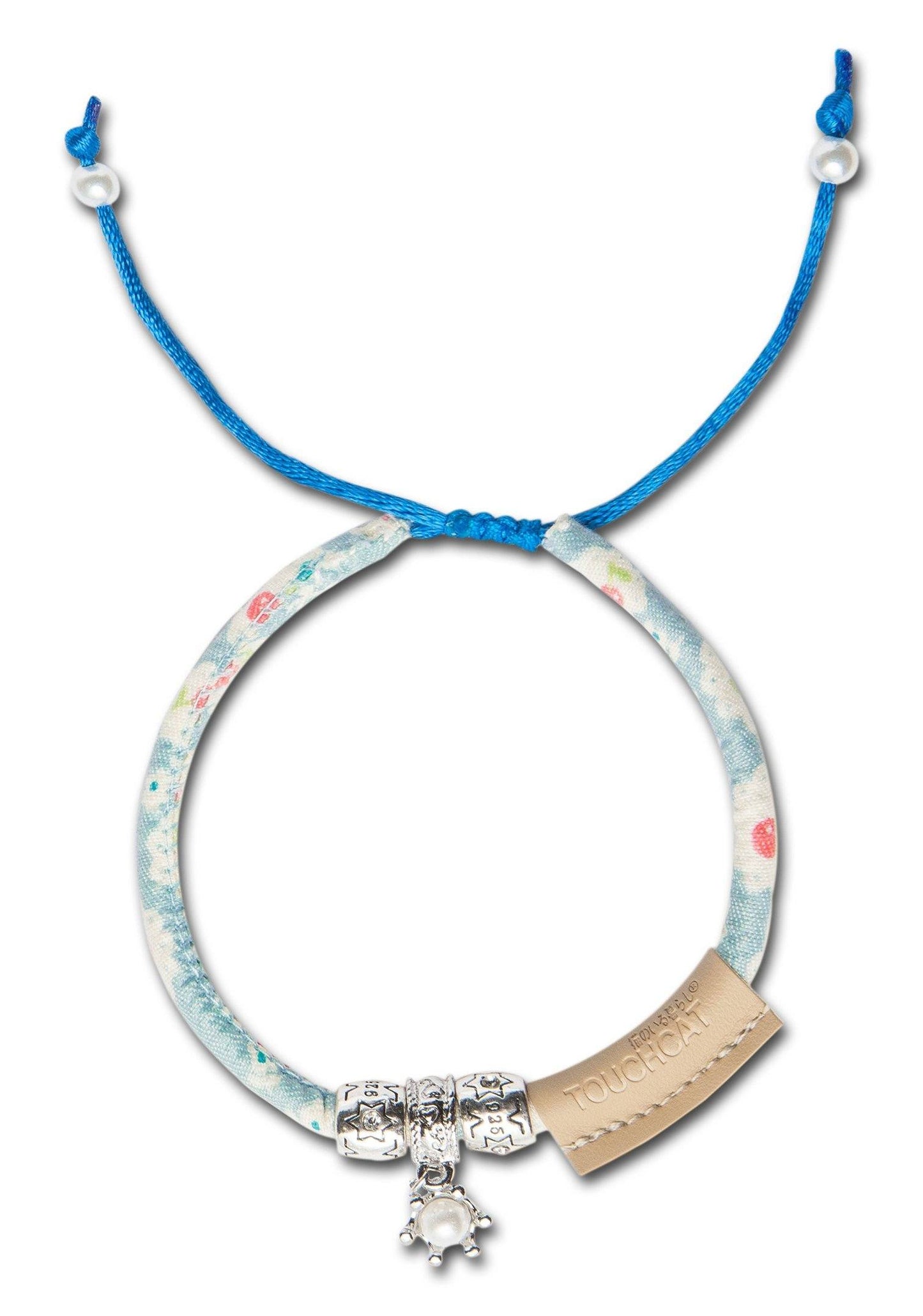 Necklace with blue cord, floral-patterned band, and silver clasp on a white background