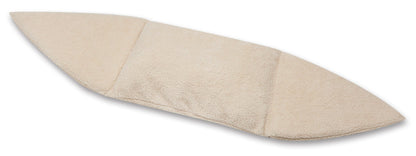 Beige surfboard-shaped bath mat on a white background