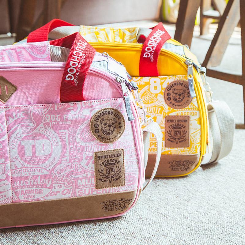 Two bags, one pink and one yellow, with visible branding on a light surface.