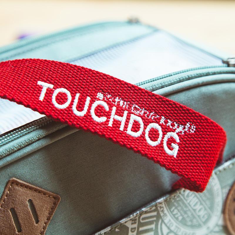 Red 'TOUCHDOG' strap on a suitcase