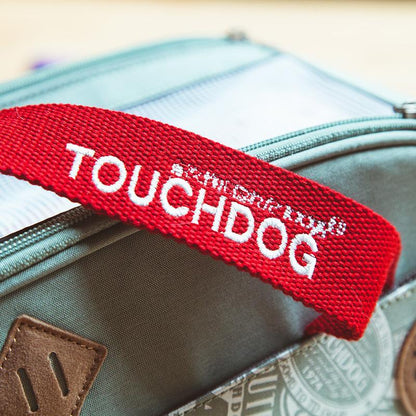 Red 'TOUCHDOG' strap on a suitcase