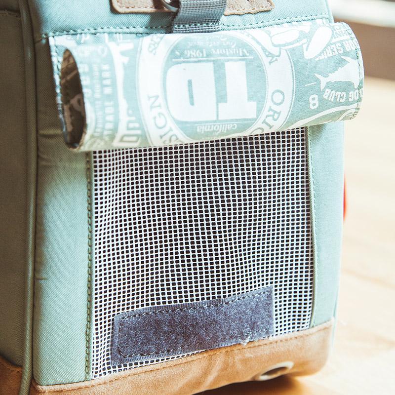 Light blue bag with a mesh pocket and visible brand logo.