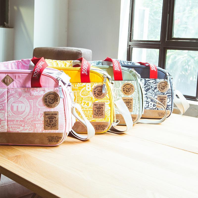 Five colorful handbags on a wooden table with a window in the background