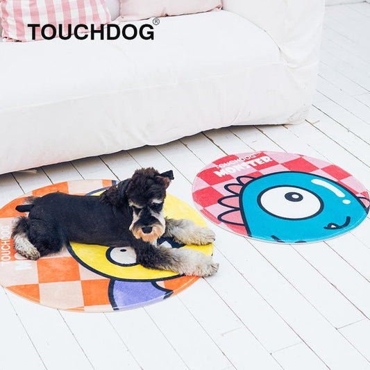 Dog lying on a colorful round mat with 'Touchdog' branding, on a white wooden floor.