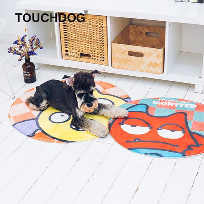 Dog lying on a colorful round mat with 'Touchdog' branding, in front of a white cabinet with wooden baskets.