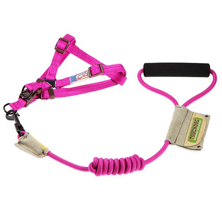 Pink dog harness and leash set with handle on a white background 
