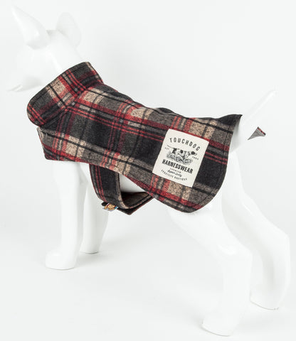 Plaid dog harness on a mannequin with a visible brand label against a white background