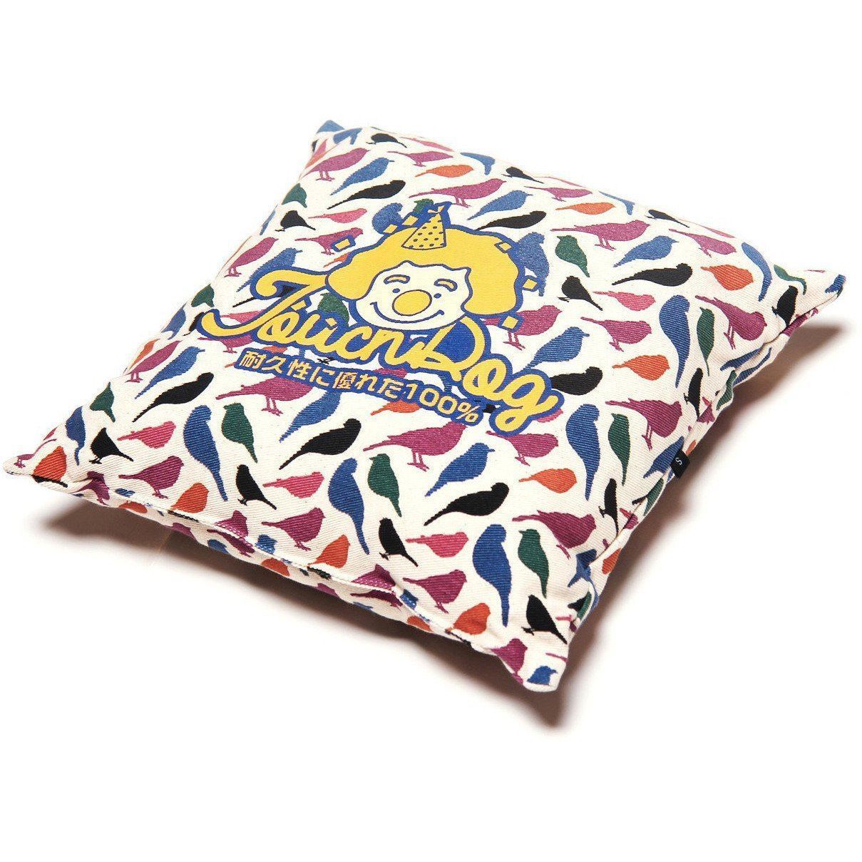 Colorful pillow with bird pattern and 'Juch Dog' branding on a white background