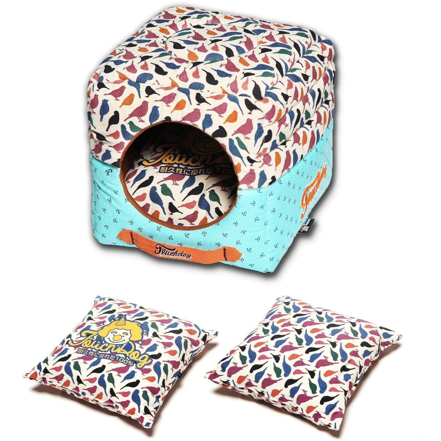 Colorful pet house with bird pattern and two matching pillows on a white background