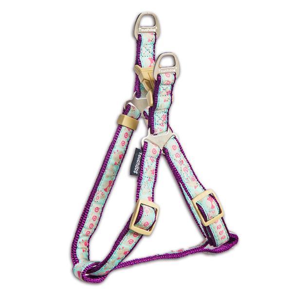 Floral-patterned dog harness with purple accents on a white background