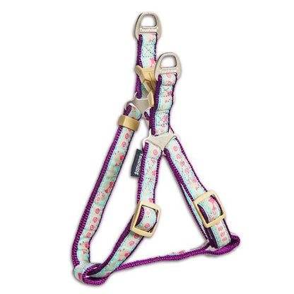 Floral-patterned dog harness with purple accents on a white background