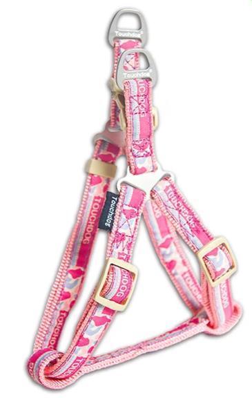 Pink dog leash with floral pattern and gold buckle on a white background