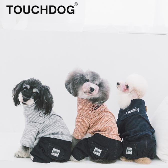 Three dogs wearing Touchdog pet clothing on a white background