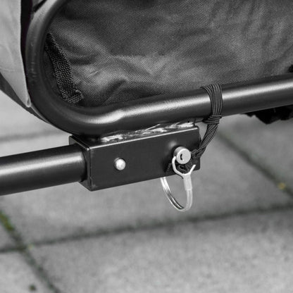 Close-up of a metal bracket attached to a mesh bag on a gray surface